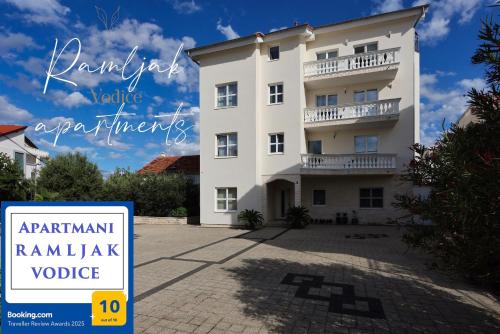 a building with a sign in front of it at Apartment R A M L J A K - Apartman "Rafael" in Vodice