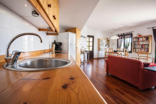 a kitchen with a sink on a wooden counter top at Apartament amb vistes al castell - Cal Martí in Montsonis