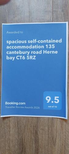 a blue sign sitting on top of a wooden table at spacious self-contained accommodation 135 cantebury road Herne bay CT6 5RZ in Kent