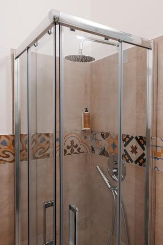 a shower with a glass door in a bathroom at Vacanze da Beppuccio Scoglitti in Vittoria