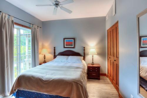 a bedroom with a bed and a window at Cap Tremblant in Mont-Tremblant