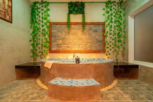 a bathroom with a large tub with a sink at Angkor Rithy Residence in Siem Reap