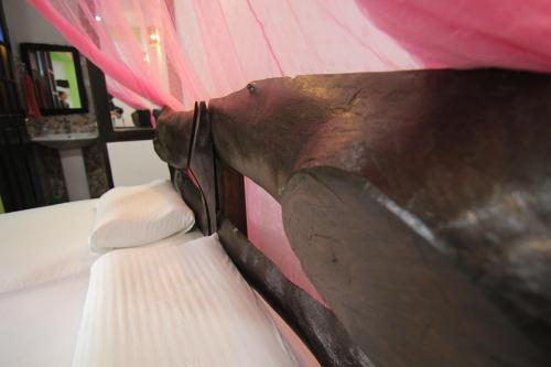 a close up of a bed with a tie on it at Villa Eden Paradise in Ella