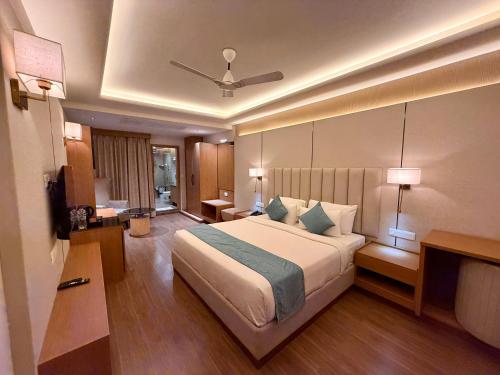 a bedroom with a large bed in a hotel room at Lalit hotel in Udaipur