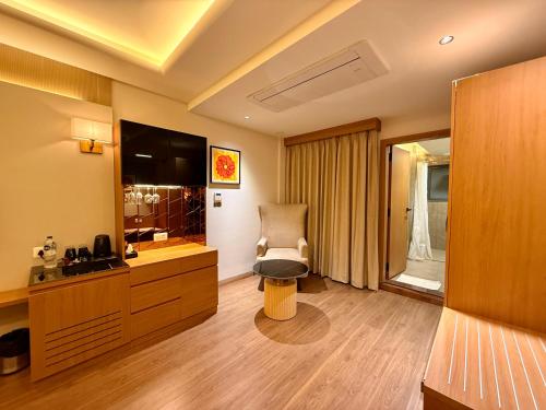 a hotel room with a chair in a room at Lalit hotel in Udaipur