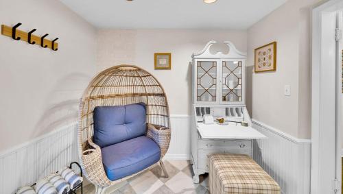 a room with a blue chair in a wicker swing at In-ground pool, hot tub, fire pit, massage room! in Tulsa