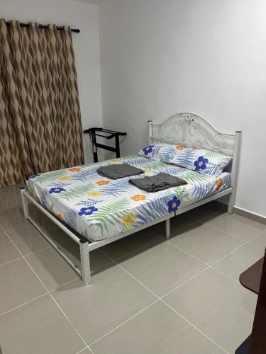 a bed in a room with at SaiMurni Homestay in Jerantut
