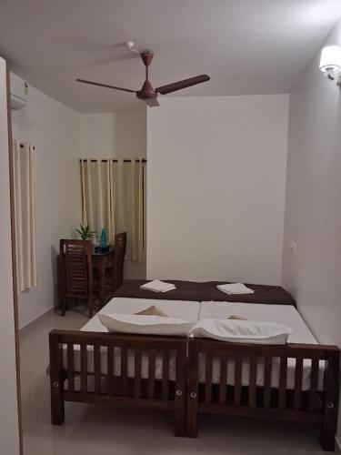 a bedroom with a bed and a ceiling fan at Eleeza Homestay in Cochin