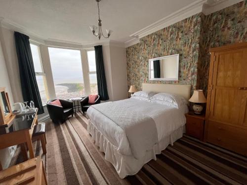 a bedroom with a bed and a large window at The Ashley in Morecambe