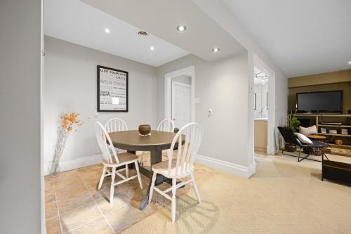 a dining room with a table and chairs at Farmhouse Stay Guelph Elora in Guelph