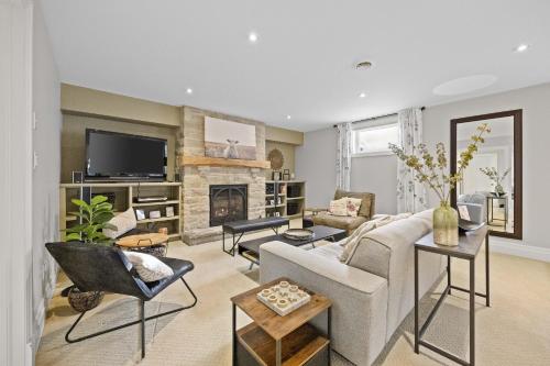 a living room with a couch and a fireplace at Farmhouse Stay Guelph Elora in Guelph
