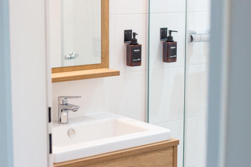 a bathroom with a white sink and a mirror at Bärenhof in Matzen