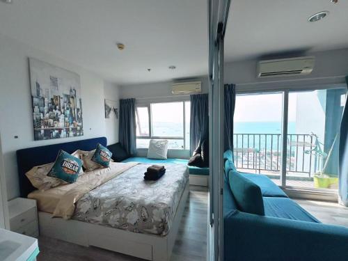 a bedroom with a bed and a view of the ocean at Pattaya Sea View Condo in Pattaya