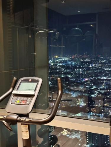 a cell phone sitting on a table in front of a window at Pattaya Sea View Condo in Pattaya