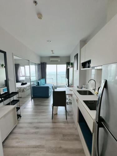 a kitchen and living room with a view of the ocean at Pattaya Sea View Condo in Pattaya