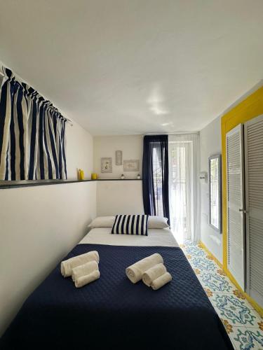 a bedroom with a large bed with two pillows on it at CASA SOFIA in Anacapri
