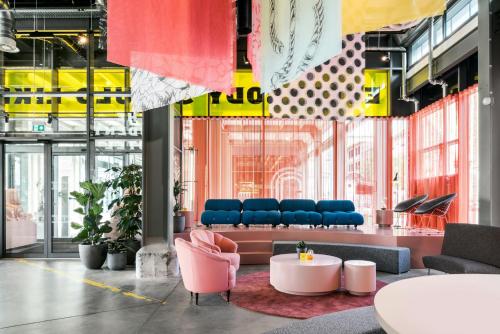 a lobby with chairs and a table in a building at The Social Hub Maastricht Extended Stay in Maastricht