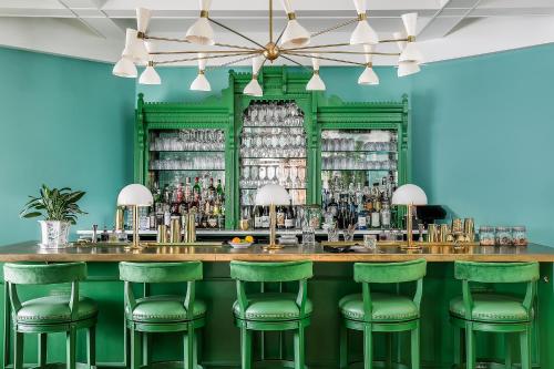 a green bar with green bar stools at Bradford House, a Member of Design Hotels in Oklahoma City