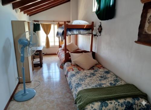 a room with a bed and a bunk bed at miradas serranas 2 in Villa Giardino