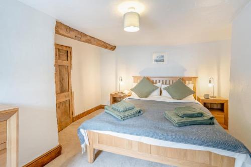 a bedroom with a bed with two pillows on it at 2 Bed in Defynnog oc-t32724 in Sennybridge