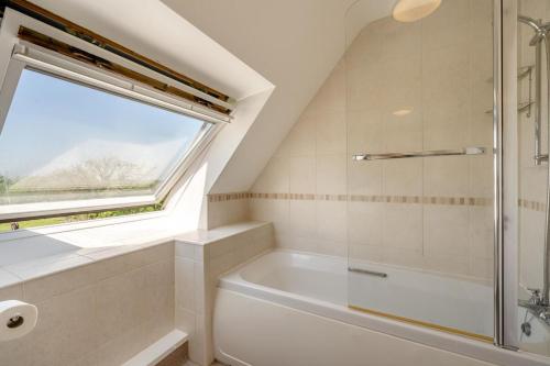a bathroom with a white tub and a window at 2 Bed in Shipham oc-s31934 in Shipham