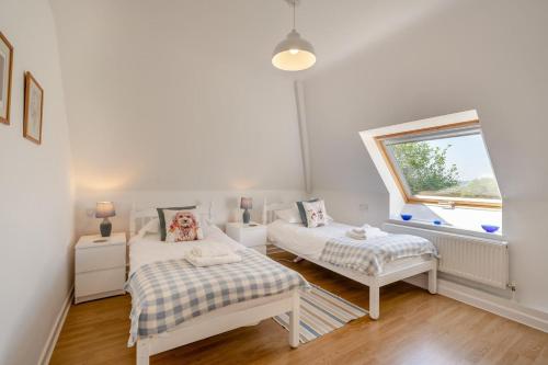 a small room with two beds and a window at 2 Bed in Shipham oc-s31934 in Shipham