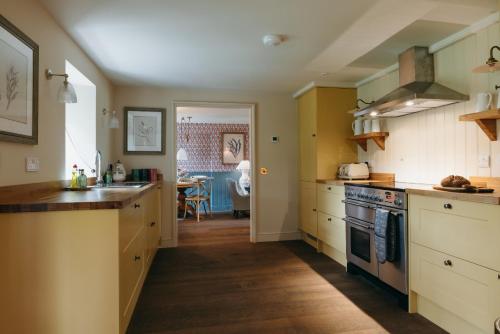 a kitchen with a sink and a stove at Muir Cottage in Aboyne