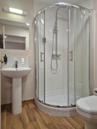 a bathroom with a shower and a sink at Woodside House in Aberdeen