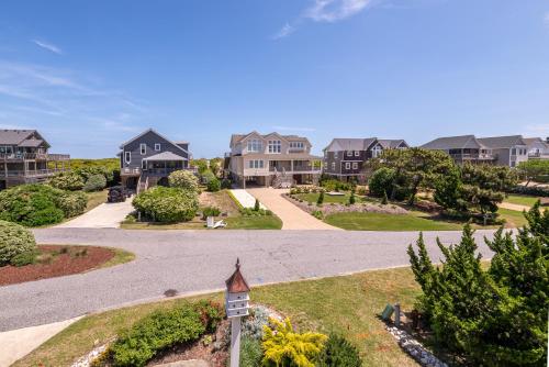 a driveway leading to homes in a subdivision at Shore Enough - Duck, Sanderling, 50 Yds to Beach, Elevator, Pets OK, Community Pool, Flex Stays in Duck