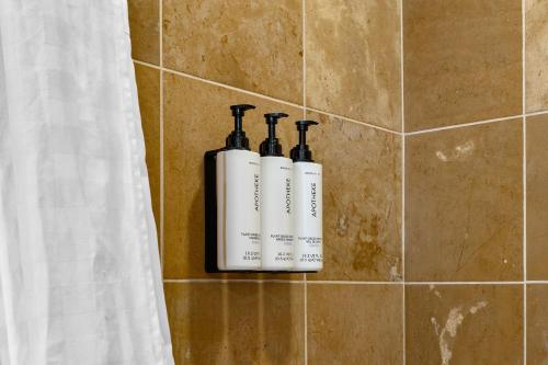two bottles of soap on a wall in a bathroom at 3033 Suncadia Riverfront Studio Lodge Pool Access in Cle Elum