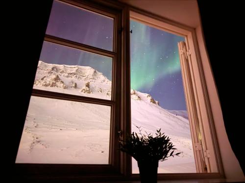 a window with a view of a snowy mountain at Gjestehuset 102 - your home away from home! in Longyearbyen
