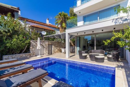 a swimming pool in the backyard of a house at Villa Gunes in Kalkan