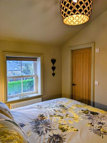 a bedroom with a large bed and a window at Pudsey Loft Apartment in Pudsey