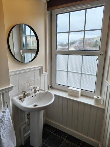 a bathroom with a sink and a mirror at Fintry Inn in Fintry