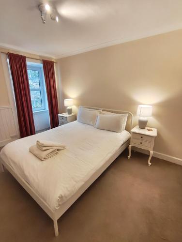 a bedroom with a bed with two lamps on it at Fintry Inn in Fintry