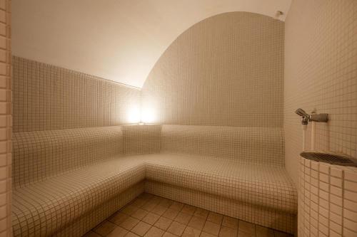 eine weiß geflieste Dusche mit Beleuchtung im Badezimmer in der Unterkunft Südwind 13 in Zempin
