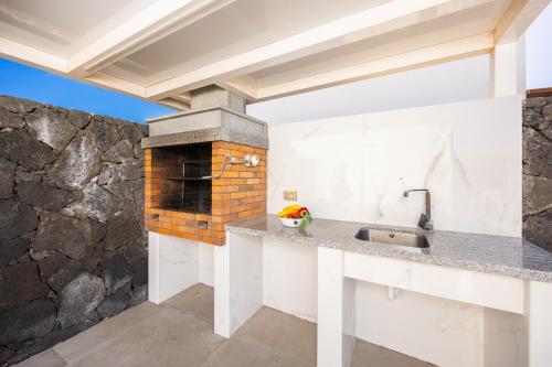 a kitchen with a stone wall at Villa Yaiza Secret 3 in Yaiza
