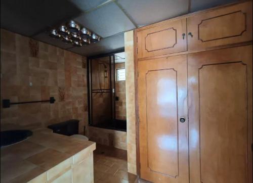 a kitchen with wooden cabinets and a sink at Hostel La Casona in Medellín