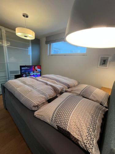 two beds sitting in a room with a window at The view - Helfenberg in Ilsfeld