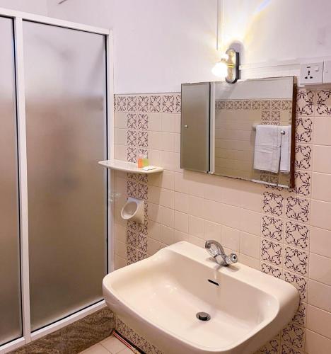 a bathroom with a sink and a shower at Bungalow 36 in Kandy