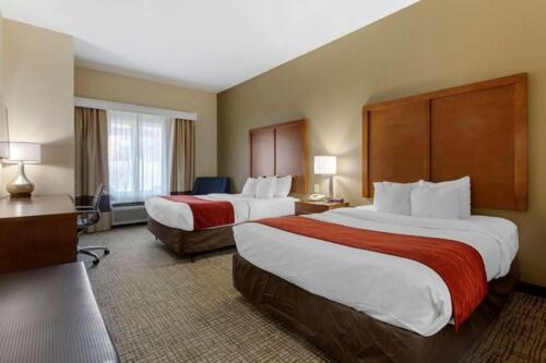 a hotel room with two beds and a television at Springplace Inn & Suites in Marion