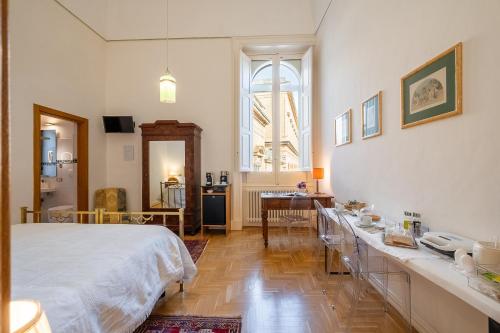 a bedroom with a white bed and a table with dishes at Palazzo De Giorgi B&B in Lecce