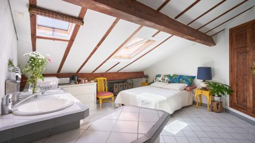 a bathroom with a bed and a sink in a room at Studio atypique de charme in Cannes