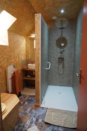 a bathroom with a shower with a glass door at Plantes et sabots in Barriac-les-Bosquets