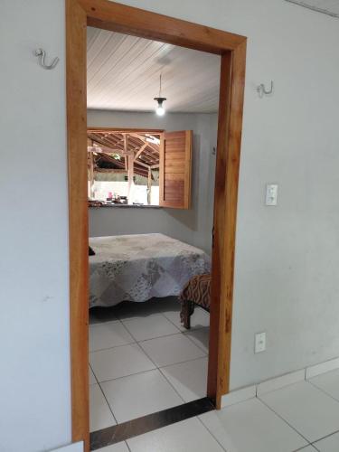 a doorway into a bedroom with a bed in it at POUSADA Botos de Alter quarto compartilhado in Alter do Chao