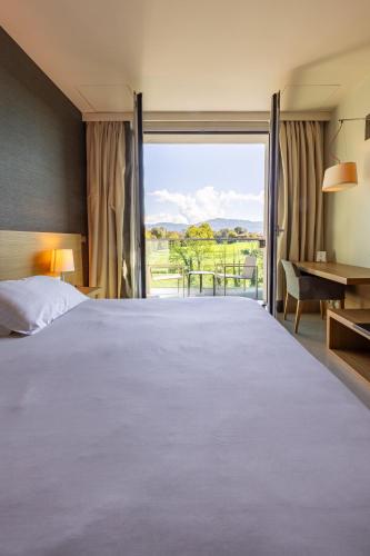 a bedroom with a large bed and a large window at HSM Hotel San Martino in Garbagnate Monastero 