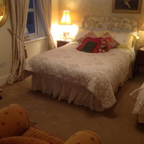 a bedroom with a bed with a book on it at Killyliss Country House B&B in Lisnalong