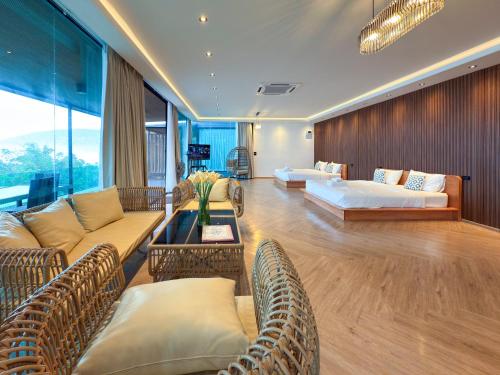 a living room with two couches and a couch at Laguna Khaokho in Khao Kho