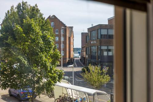 a view from a window of a street with a bus at Castle Lanes - Minutes from Poole Quay, Poole Town Location in Poole