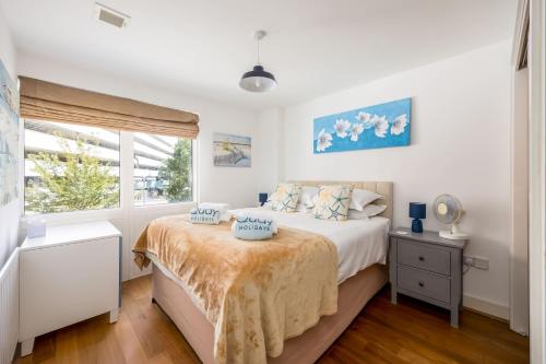 a white bedroom with a bed and a window at Castle Lanes - Minutes from Poole Quay, Poole Town Location in Poole